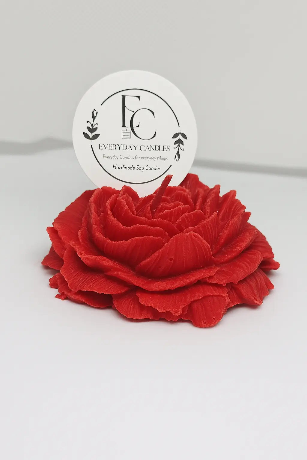 Handmade rose-shaped soy candle in red, detailed petals, small-batch crafted in BC.